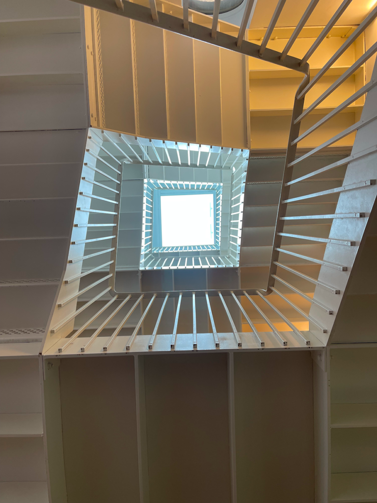 Staircase shot from the bottom looking up at a skylight